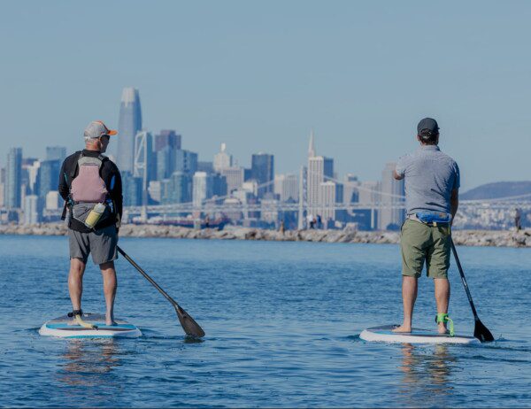 2 Stand-Up Paddleboarders enjoying the magnificent views of San Francisco from a guided Stand Up Paddleboard tour out of Sausalito.